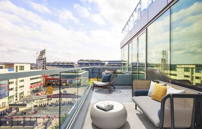 a balcony with a couch a chair and a table
