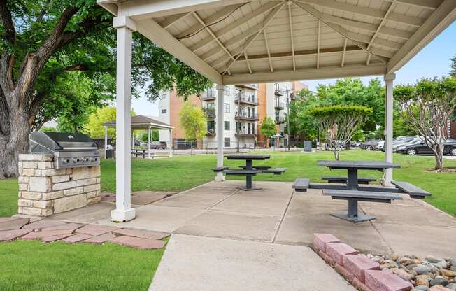 A covered picnic area with tables and benches.
