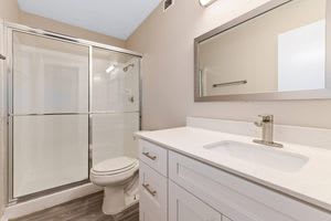 a bathroom with a toilet sink and shower