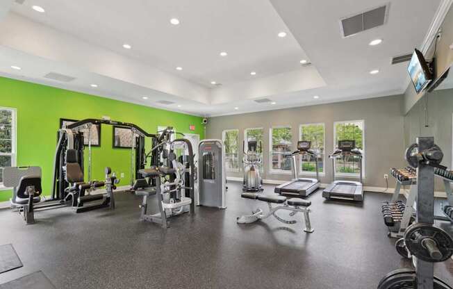 A spacious gym with a variety of equipment.