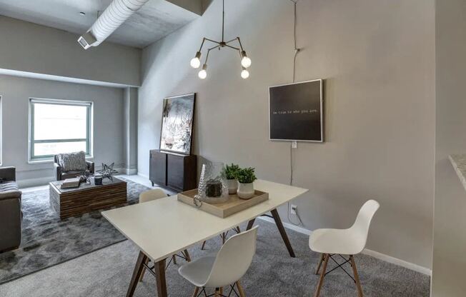 a dining room with a white table and chairs