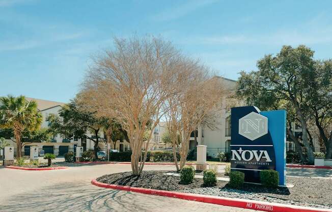 A sign for Nova Gris Partners stands in front of a building.