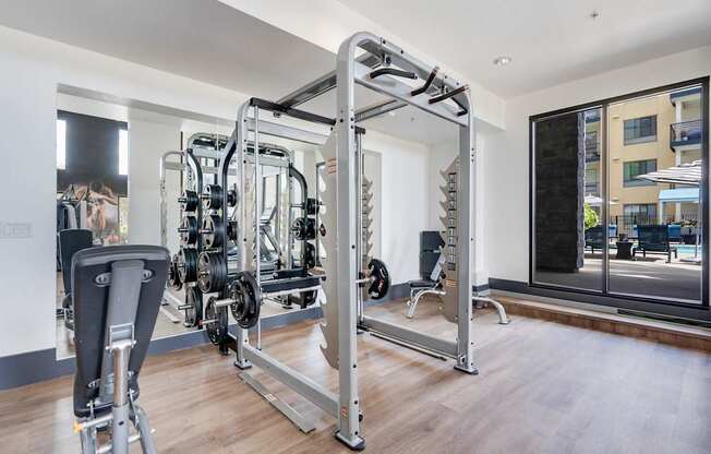 A gym with a variety of equipment including a leg press machine.