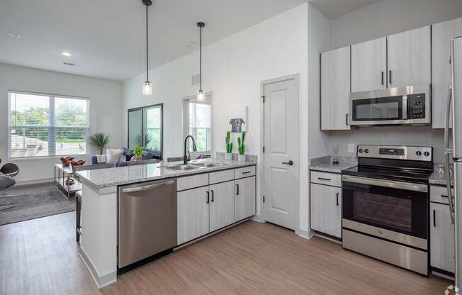 A modern kitchen with stainless steel appliances and white cabinets.