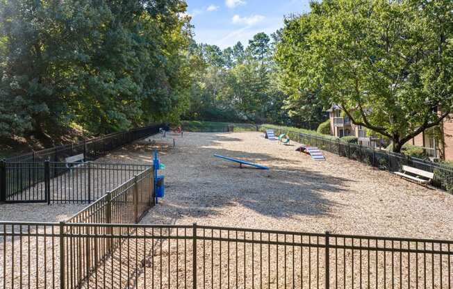 a playground in a park with benches and trees at View at Lake Lynn, Raleigh, 27613