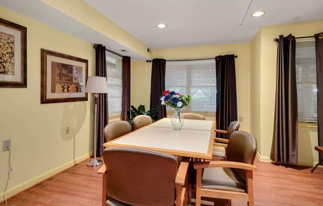 a dining room with a table and chairs