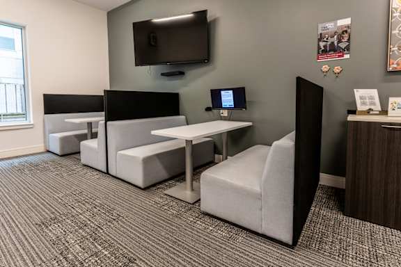 a living room with couches and a tv at The Whit Apartments, Indianapolis, IN
