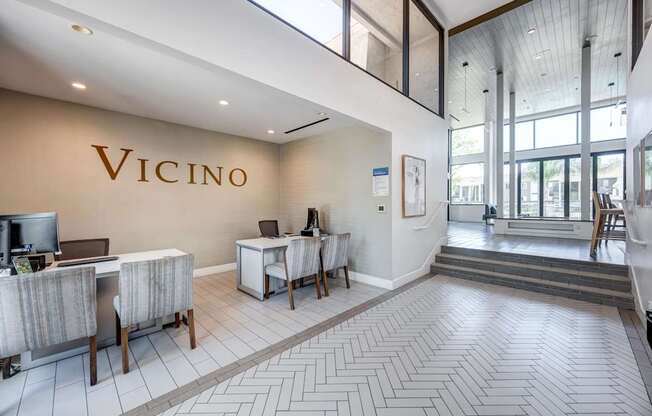 Vicino's interior lobby area with a reception desk and chairs.