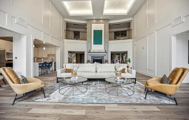 A living room with a white sofa, two chairs, and a coffee table.