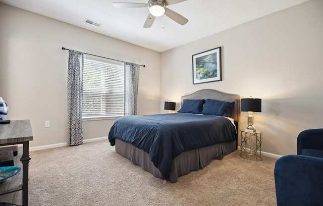 a bedroom with a bed and a ceiling fan