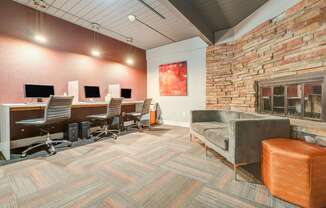 A room with a brick wall and a couch.