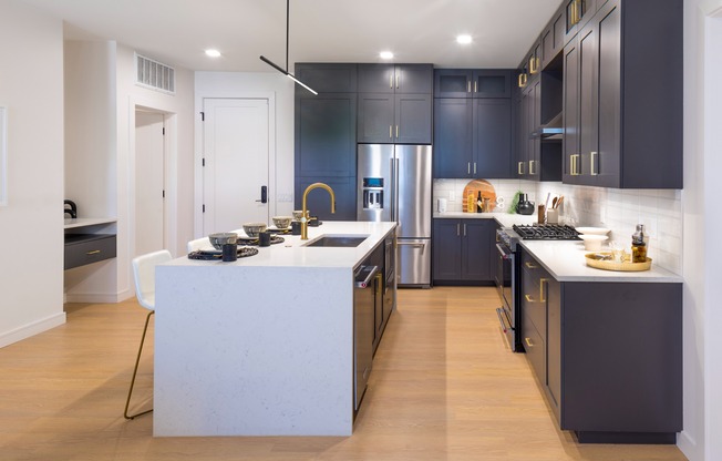 Gourmet kitchens with custom cabinetry, brushed brass hardware and under-cabinet lighting