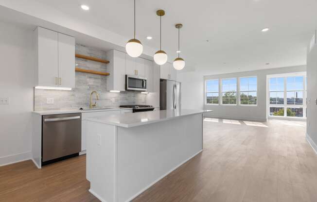 a large white kitchen with an island and stainless steel appliances at Rialto, Washington, DC