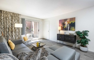 a living room with a gray couch and a tv