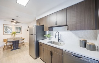 a kitchen with cabinets and a stainless steel refrigerator