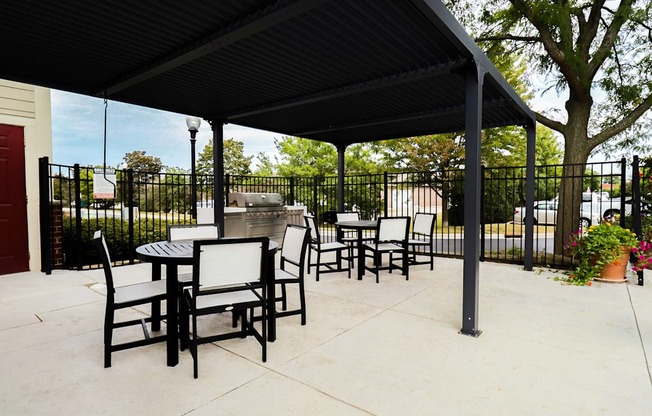 A black metal patio with a table and chairs.