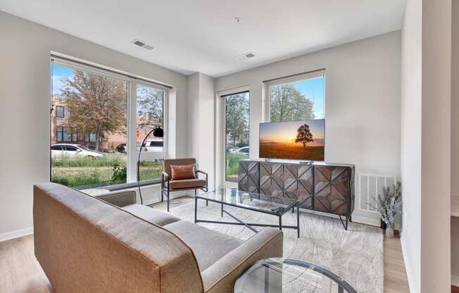 a living room with a tv on the wall and a couch in front of it