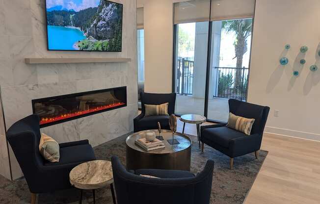 A living room with a fireplace and a television on the wall.