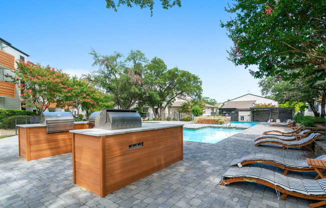 a backyard with a hot tub and lounge chairs