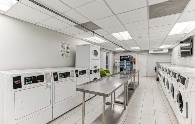 A laundromat with a row of washers and dryers.