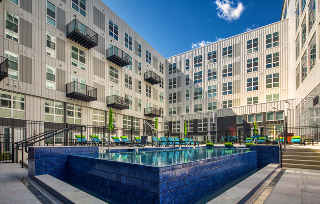 a large pool in front of a large apartment building