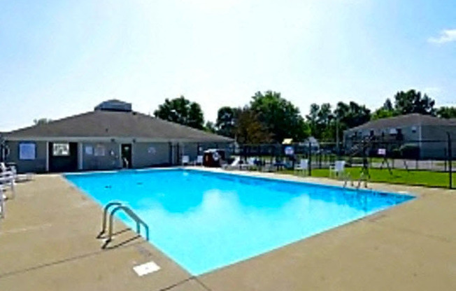 a swimming pool with a building in the background