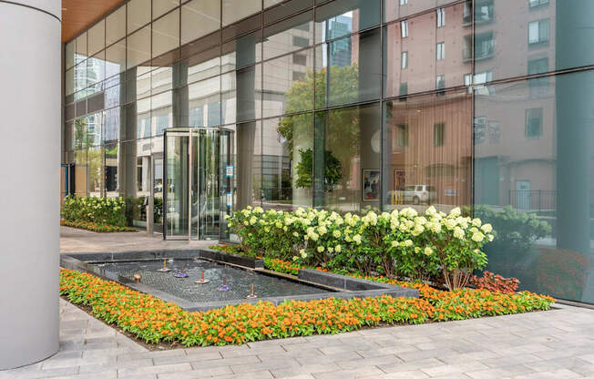 a courtyard with flowers in front of a glass building  at Cassidy on Canal, Illinois, 60606
