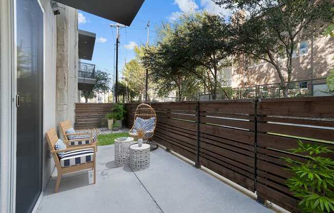 A patio with a chair and table.