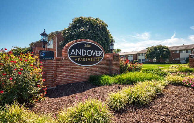 the sign apartments in front of a brick wall