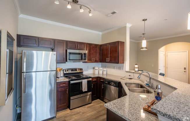 a kitchen with stainless steel appliances and granite counter tops