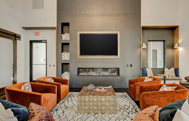 Resident lounge with vibrant seating and a television in the preserve apartments, located near Colleyville TX.