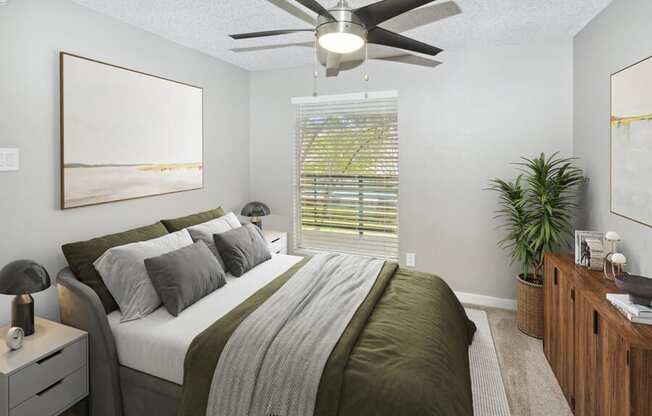 a bedroom with a large bed and a ceiling fan