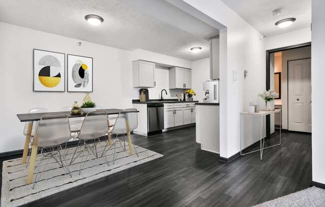 Kitchen and Dining Room with White Cabinets and Dark Hard Wood Flooring