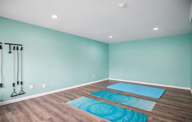 A room with a yoga mat on the floor.