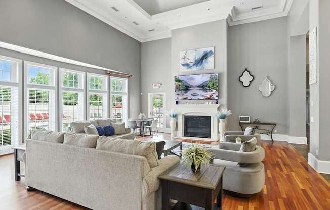 A living room with a grey couch and a fireplace.