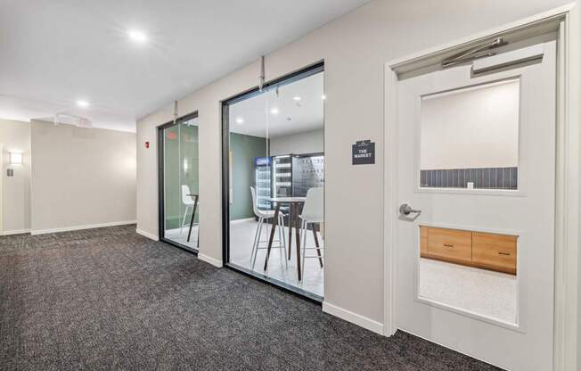 a conference room with glass doors and a table and chairs