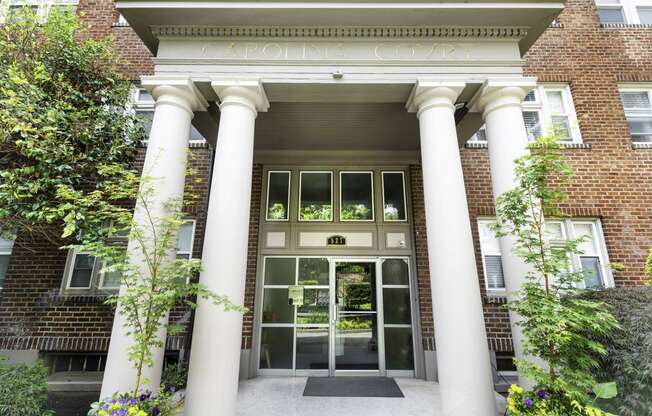 a picture of the front of a building with large white columns