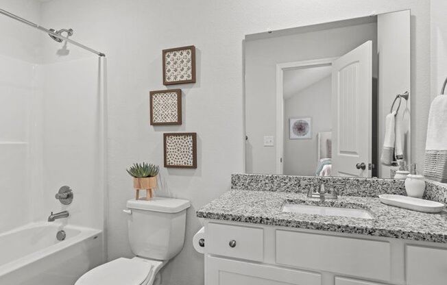 a bathroom with a sink toilet and a mirror