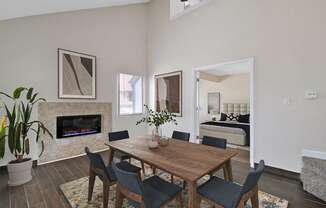 a dining room with a table and chairs and a fireplace