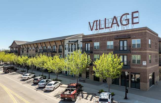 a large building with a sign on the side of a street