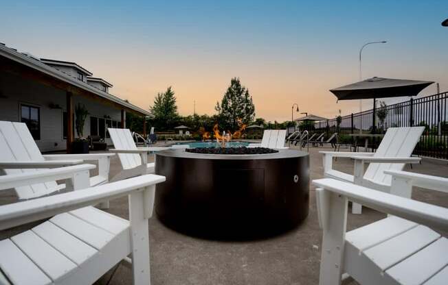 a round fire pit with white chairs around it at Sonder Fields in Happy Valley, OR