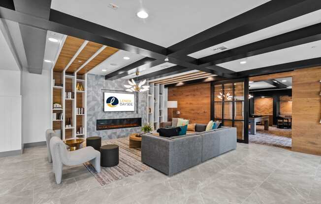 a lobby with a couch and chairs and a fireplace