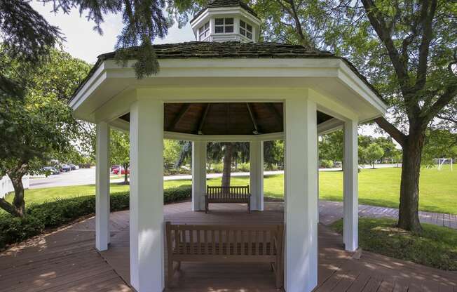 a gazebo in a park with a bench at Village Club of Rochester Hills, Shelby Township, MI