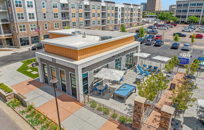 an aerial view of the building with a parking lot in the background
