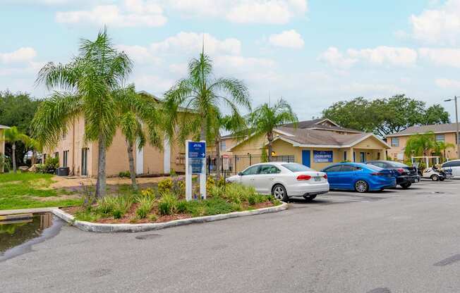 A parking lot with cars and a building in the background.