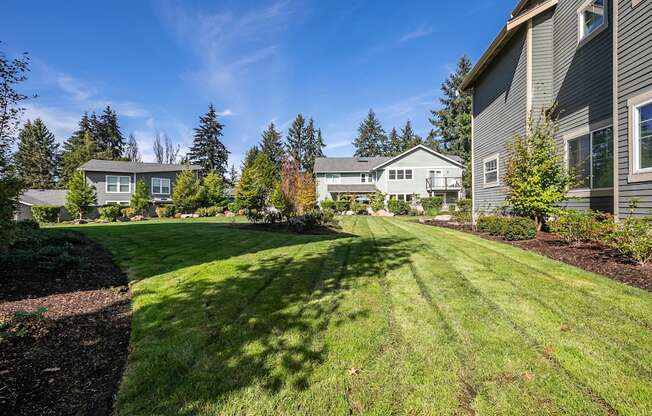 A residential area with houses and green lawns.