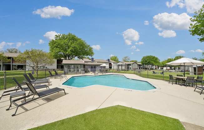 the preserve at ballantyne commons pool and patio with chairs and umbrellas