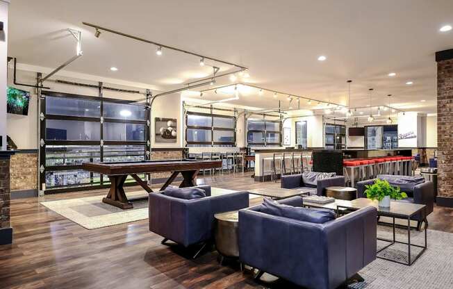 a lounge area with couches and tables and a pool table