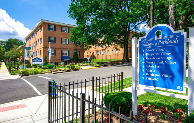 A sign in front of a building that says Villages of Parklands.