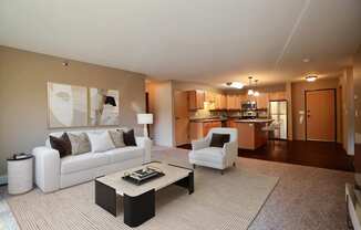 a living room with a couch and a table. Fargo, ND Urban Plains Apartments